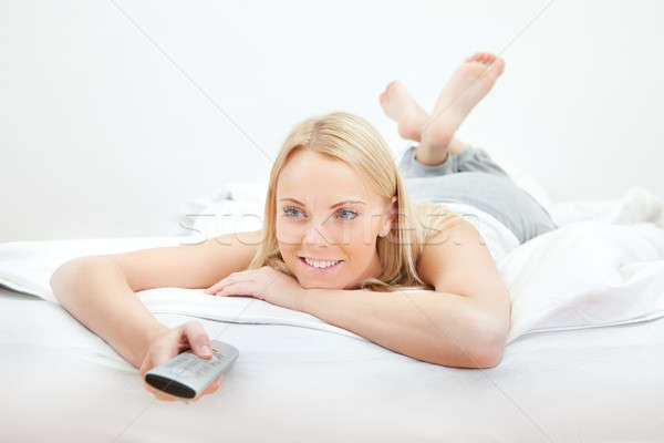 Young beautiful woman lying in bed Stock photo © AndreyPopov