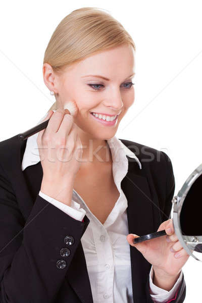 Attractive businesswoman applying foundation Stock photo © AndreyPopov