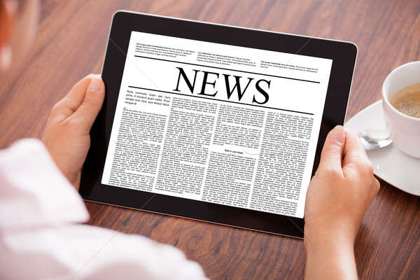 Woman Looking At News Article Stock photo © AndreyPopov