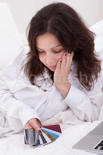 Woman contemplating her credit cards Stock photo © AndreyPopov