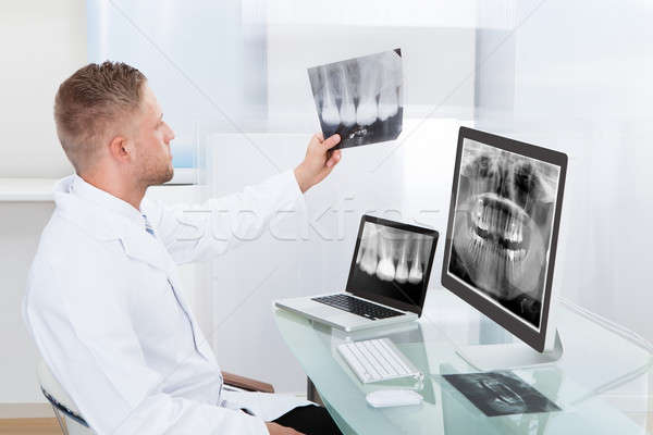 Doctor or radiologist looking at an x-ray online Stock photo © AndreyPopov