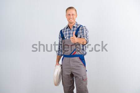 Smiling Worker Standing Arms Crossed Over White Background Stock photo © AndreyPopov