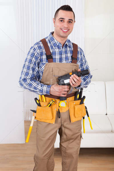 Repairman Holding Drill Machine In Living Room Stock photo © AndreyPopov