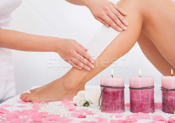 Beautician Waxing A Woman's Leg Stock photo © AndreyPopov