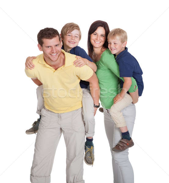 Happy Parents Piggybacking Children Stock photo © AndreyPopov