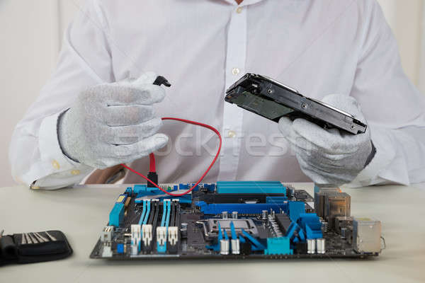 Technician With Motherboard And Harddisk Stock photo © AndreyPopov
