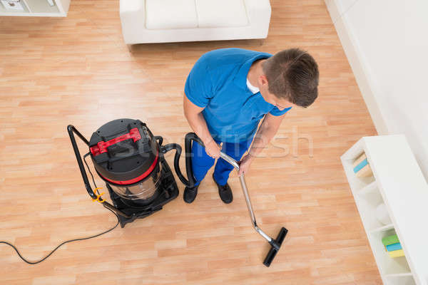 Janitor Cleaning Floor With Vacuum Cleaner Stock photo © AndreyPopov