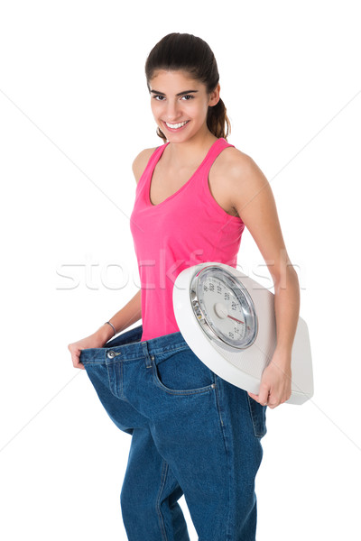 Lächelnde Frau Gewicht Maßstab alten Jeans Stock foto © AndreyPopov