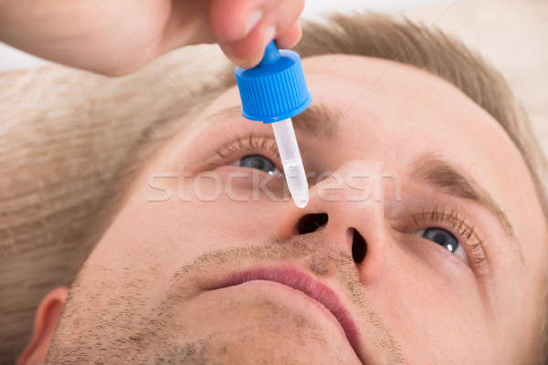 Man Using Nasal Spray Stock photo © AndreyPopov