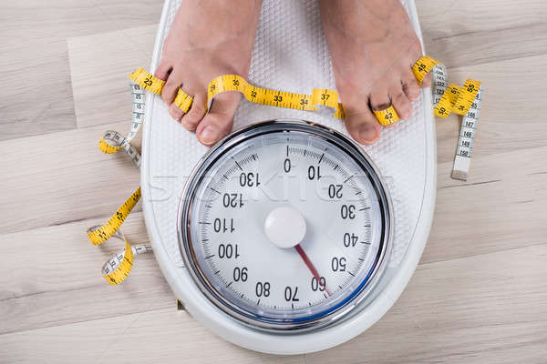 Person Leg On Weighing Scale Stock photo © AndreyPopov