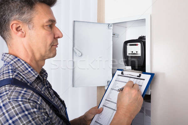 Male Technician Writing Reading Of Meter Stock photo © AndreyPopov