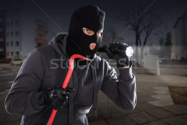 Burglar With A Crowbar And A Flashlight Stock photo © AndreyPopov