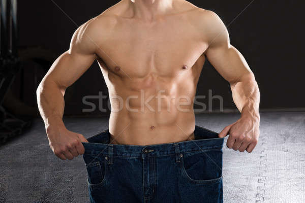 Man Wearing Loose Jean In The Gym Stock photo © AndreyPopov