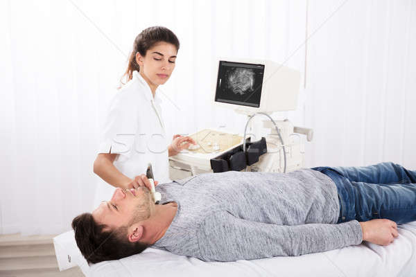 Man Getting Ultrasound Of A Thyroid From Doctor Stock photo © AndreyPopov