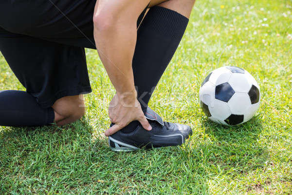 Masculina futbolista sufrimiento tobillo lesión primer plano Foto stock © AndreyPopov
