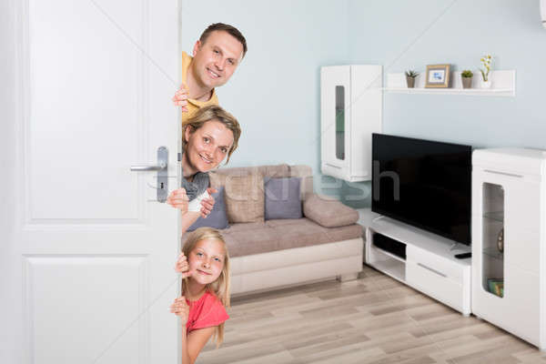 Portrait Of Happy Family Peeking From Door Stock photo © AndreyPopov