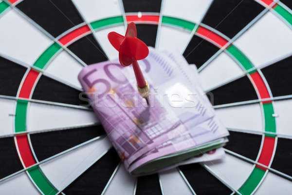 Arrow In Papernotes On Dartboard At Table Stock photo © AndreyPopov