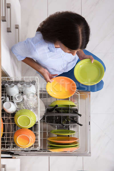 Fiatal nő tányérok mosogatógép magasról fotózva kilátás otthon Stock fotó © AndreyPopov
