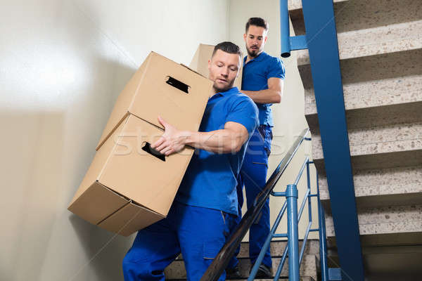Two Movers Carrying Cardboard Boxes On Staircase Stock photo © AndreyPopov