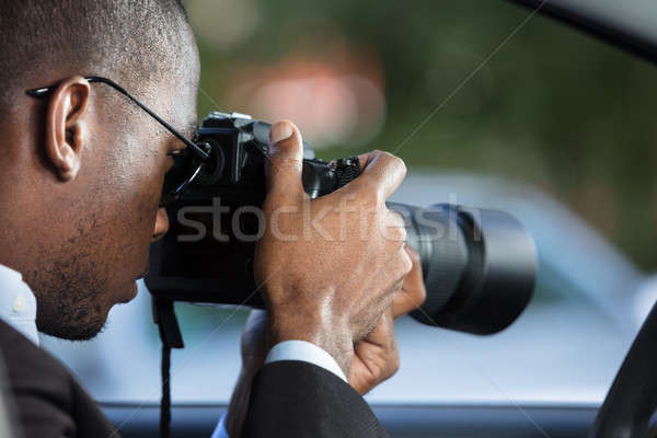 Private Detective Sitting Inside Car Photographing Stock photo © AndreyPopov