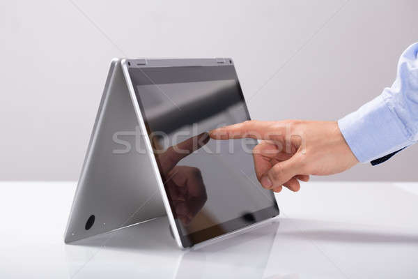 бизнесмен прикасаться пальца гибридный ноутбука экране Сток-фото © AndreyPopov