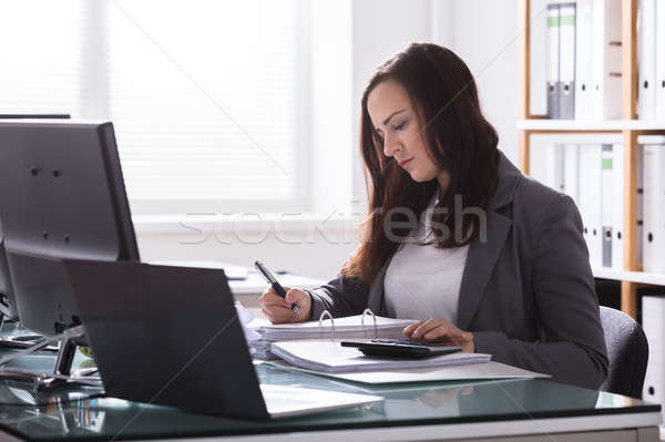 Happy Businesswoman Calculating Bill Stock photo © AndreyPopov