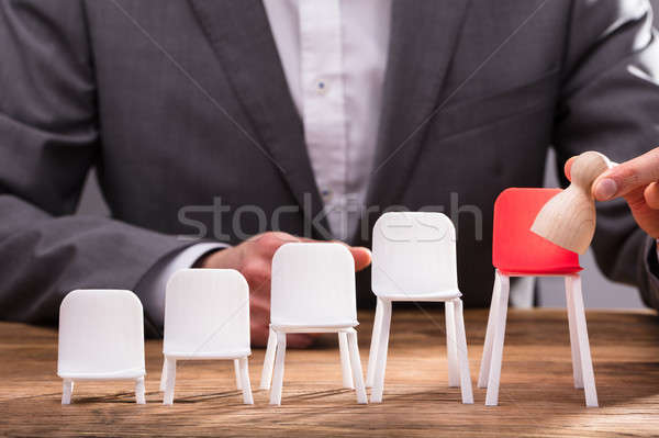 Businessperson Placing Pawn On Red Chair Stock photo © AndreyPopov