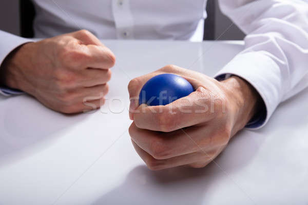 üzletember kisajtolás stressz labda kéz kék Stock fotó © AndreyPopov