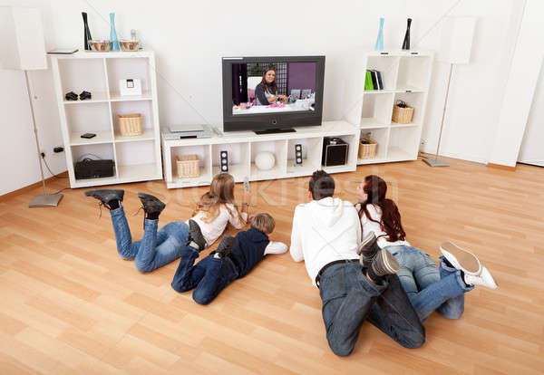 молодые семьи смотрят телевизор домой вместе Сток-фото © AndreyPopov
