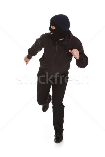 Bandyta czarny maska uruchomiony z dala człowiek Zdjęcia stock © AndreyPopov