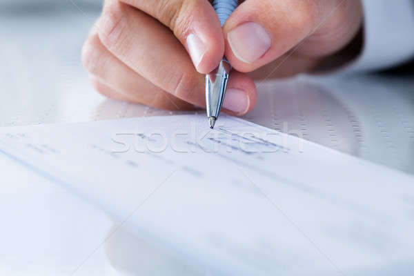 Close-up Of Hand Filling Cheque Stock photo © AndreyPopov