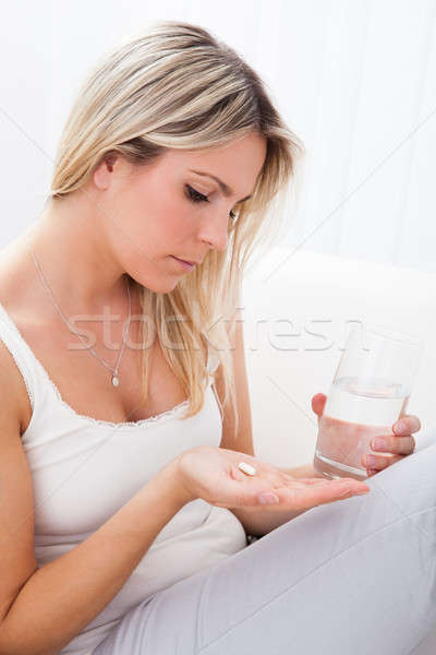 Portrait of woman taking pills Stock photo © AndreyPopov