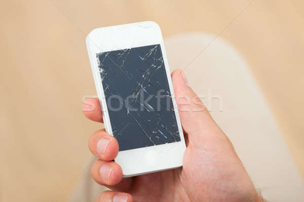 Hand Holding Smartphone With Broken Screen Stock photo © AndreyPopov