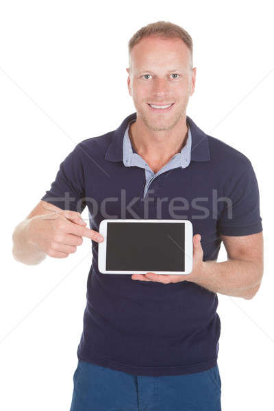 Handsome Man Displaying Digital Tablet Stock photo © AndreyPopov