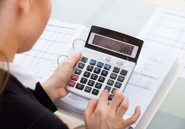 Businesswoman Calculating Bills Stock photo © AndreyPopov