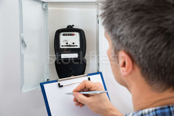 Technician Taking Reading Of Electric Meter Stock photo © AndreyPopov