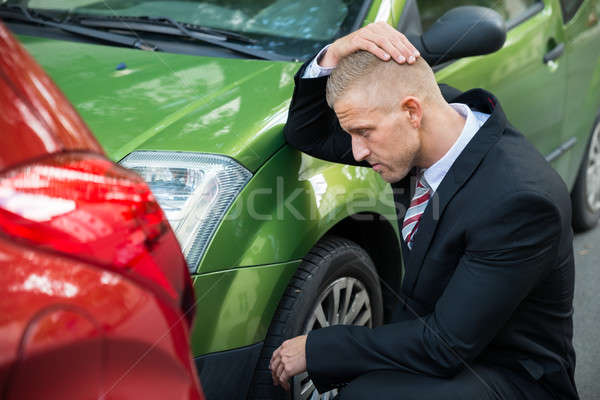 Upset Driver Looking At Car After Traffic Collision Stock photo © AndreyPopov