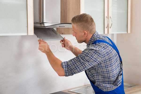 Repairman Repairing Kitchen Extractor Filter Stock photo © AndreyPopov