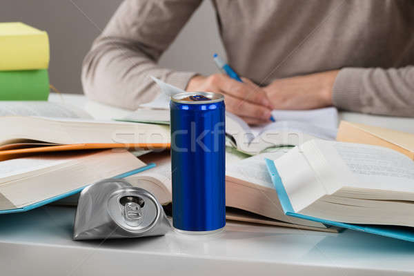 Student With Crashed Drink Can And Books At Table Stock photo © AndreyPopov