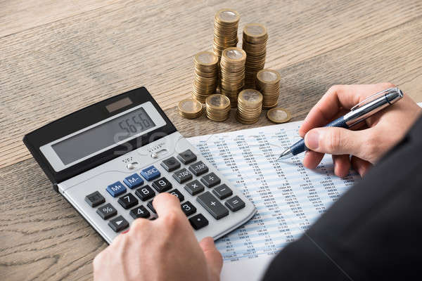 Close-up Of A Businessman Calculating Financial Report Stock photo © AndreyPopov