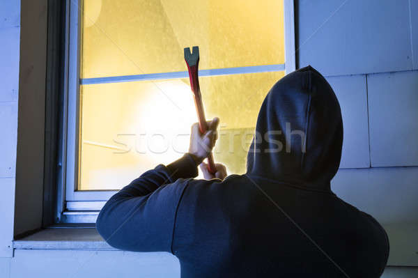 Robber Using The Crowbar To Open The Glass Window Stock photo © AndreyPopov
