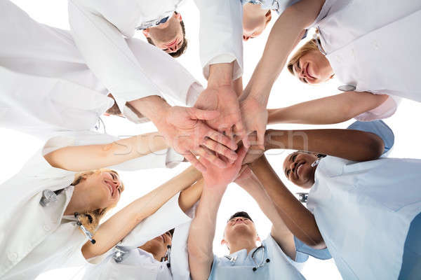 Smiling Medical Team Stacking Hands Stock photo © AndreyPopov
