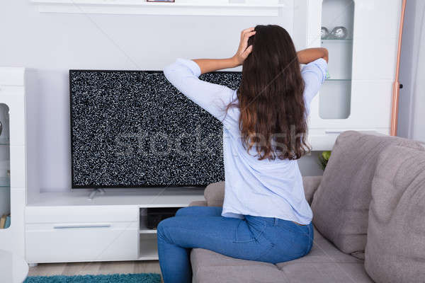 Stock photo: Woman Getting Frustrated With Glitch TV Screen