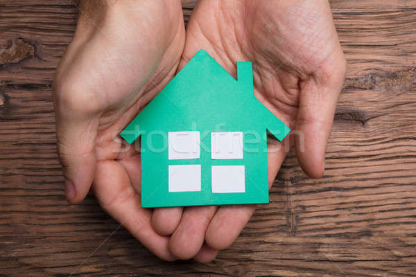 [[stock_photo]]: Mains · papier · maison · table · en · bois