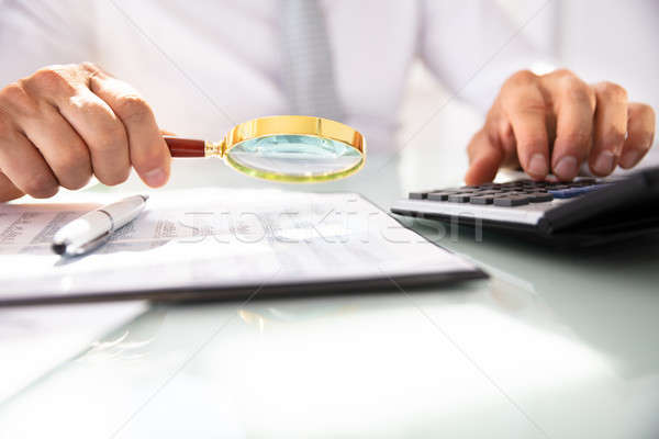 üzletember pénzügyi beszámoló nagyító kéz számológép férfi Stock fotó © AndreyPopov