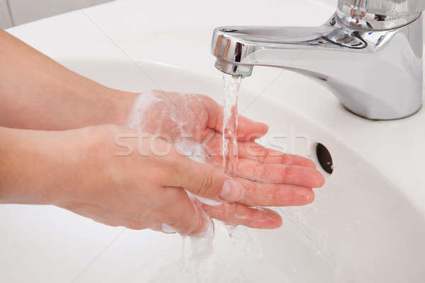 Human hands being washed under faucet Stock photo © AndreyPopov