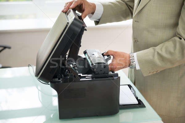 Businessman Fixing Cartridge In Photocopy Machine Stock photo © AndreyPopov