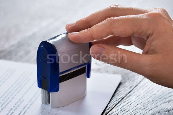 Person Hands With Stamper And Document Stock photo © AndreyPopov