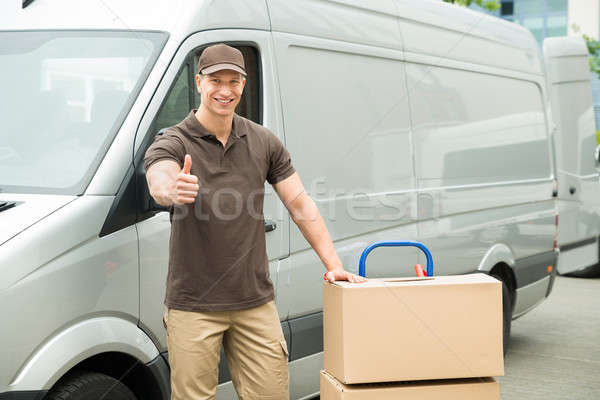 Delivery Man With Cardboard Boxes Showing Thumbs Up Sign Stock photo © AndreyPopov