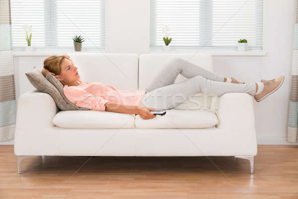 Woman Changing Channel With Remote Control Stock photo © AndreyPopov